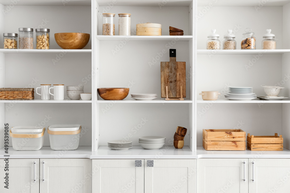 Shelf unit with clean dishware in kitchen Shelf unit with clean dishware in kitchen