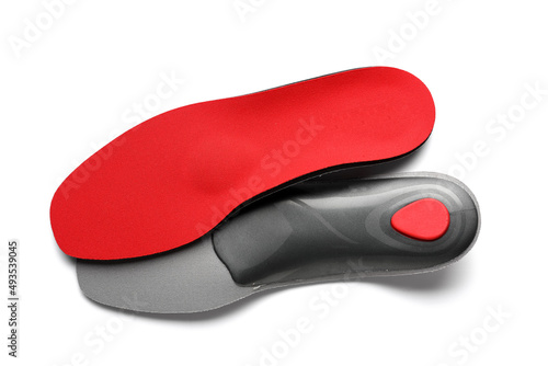 Red orthopedic insoles on white background