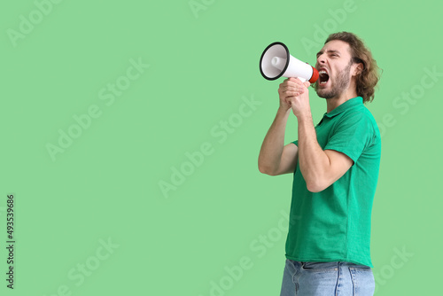 Angry young man shouting in...