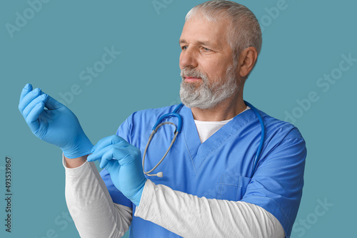 Mature male doctor with glo...