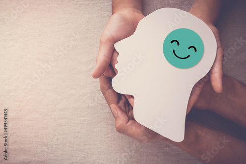 Εκτύπωση καμβά Adult and child hands holding smile face in brain paper cutout, happy hormones,