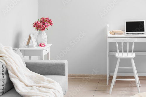 Tulips in vase on table in ...