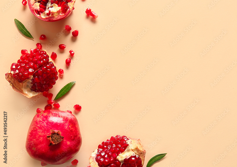 Tasty ripe pomegranate pieces on beige background Tasty ripe pomegranate pieces on beige background