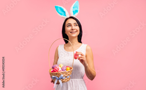 beautiful woman in rabbit ears with a basket of Easter eggs, on the Easter holiday