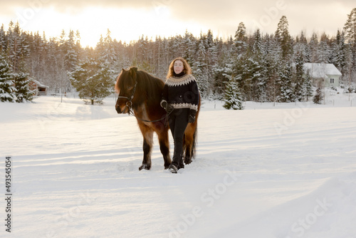 Icelandic horse and rider posing during sunset. Backlight from the sun.