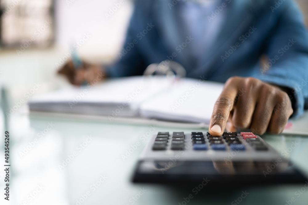 African American Male Accountant Using Calculator African American Male Accountant Using Calculator