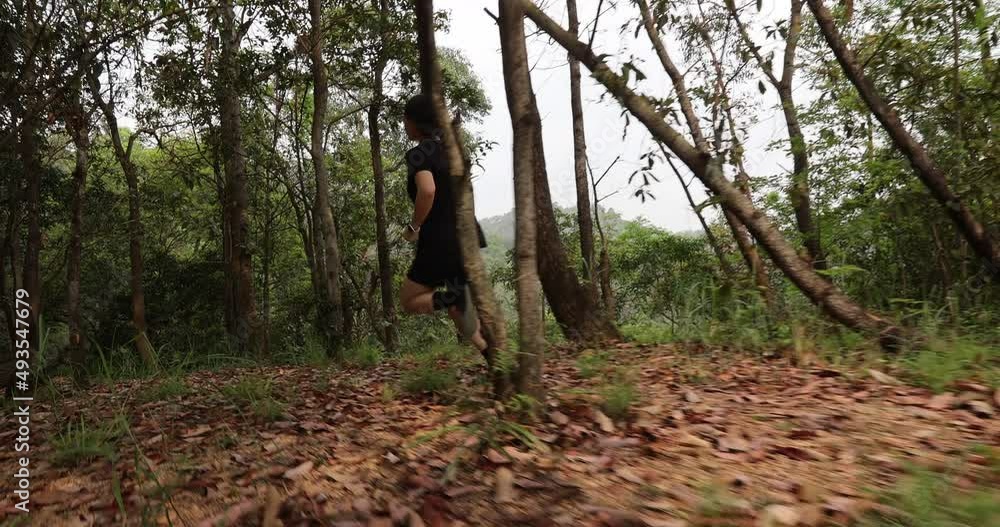 Woman runner running on forest trail Woman runner running on forest trail
