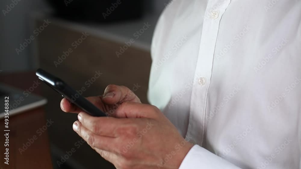 Businessman typing on smartphone, close up Businessman typing on smartphone, close up