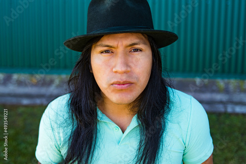 Ecuadorian indigenous man expressing feelings and technology.