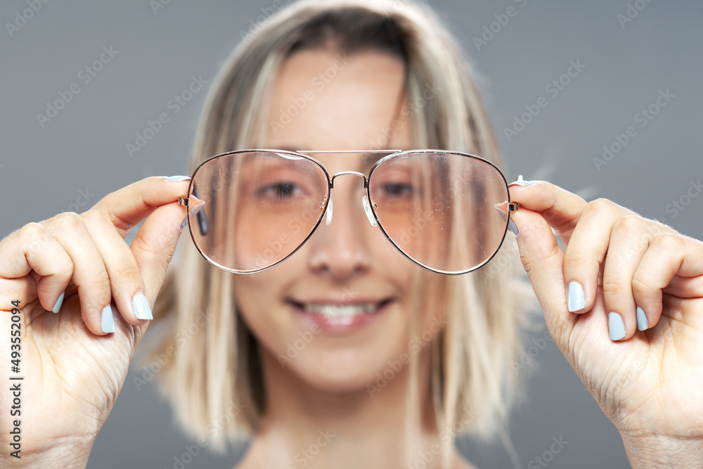 Beautiful girl fashion portrait. Holding glasses in hands Beautiful girl fashion portrait. Holding glasses in hands