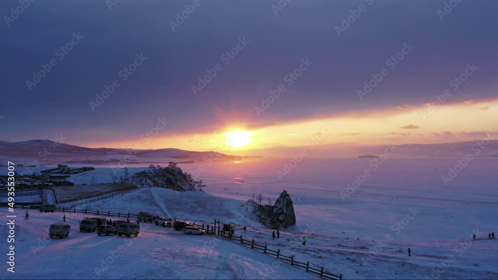 Aerial view of Shaman rock at sunset, one of sacred place in frozen lake Baikal in winter season of Siberia, Russia, 4k Aerial view of Shaman rock at sunset, one of sacred place in frozen lake Baikal in winter season of Siberia, Russia, 4k