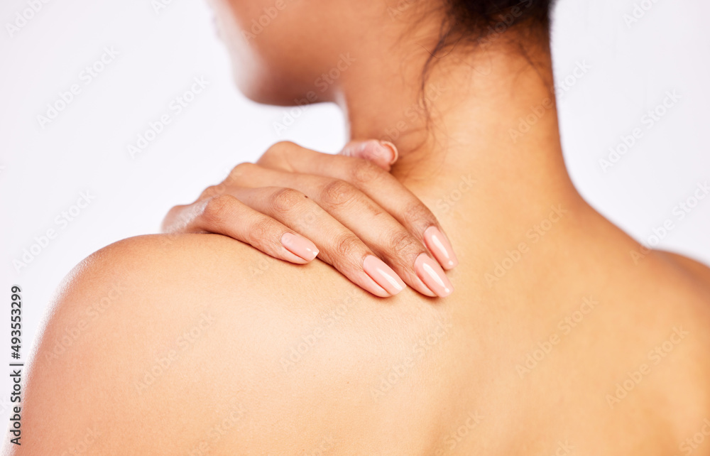 Beautiful skin doesnt just happen without proper care. Rearview shot of a young woman posing with her hand on her shoulder. Beautiful skin doesnt just happen without proper care. Rearview shot of a young woman posing with her hand on her shoulder.