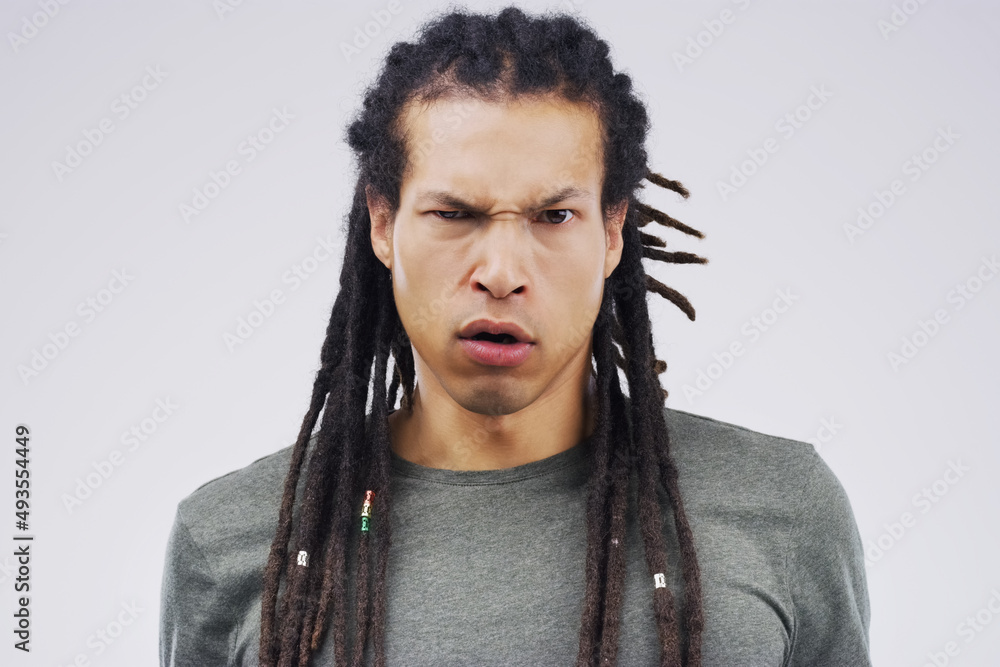 What did you say to me. Studio shot of a young man making a funny face against a gray background. What did you say to me. Studio shot of a young man making a funny face against a gray background.