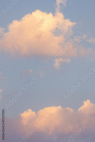 virtical bright gold pink clouds in a light blue sky