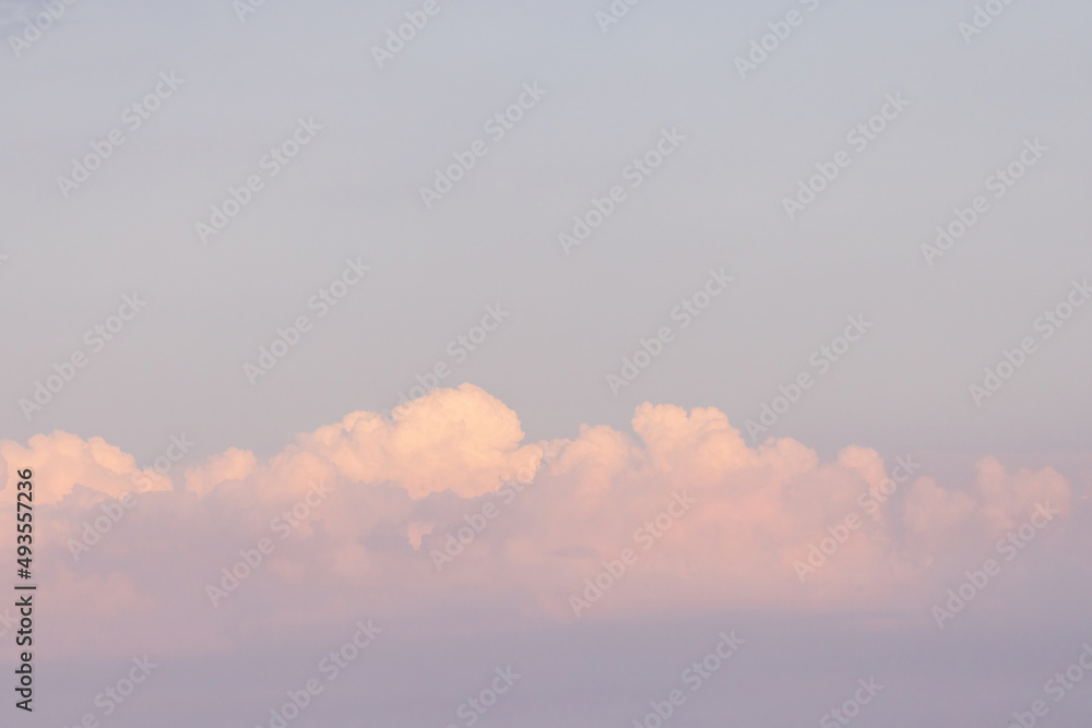 bright gold pink clouds in a light blue sky bright gold pink clouds in a light blue sky