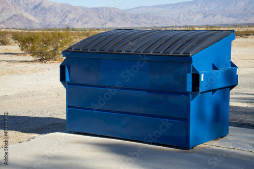 A large blue commercial dumpster for trash or recycling. photo