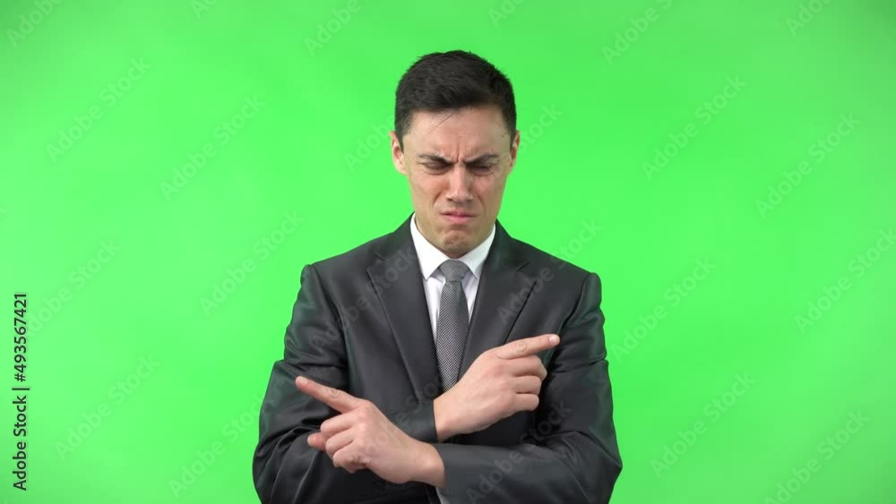 Young embarrassed businessman looking away thoughtfully in studio Young embarrassed businessman looking away thoughtfully in studio