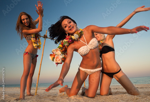 Vacationers have fun doing the limbo photo