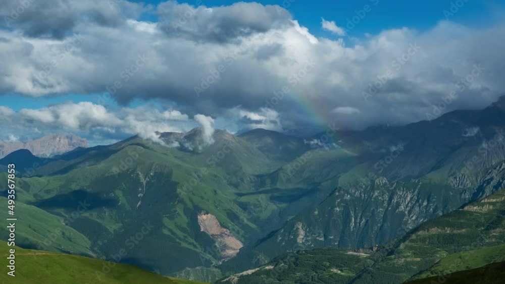 Beautiful summer landscape with rainbow and fast moving clouds in Caucasus Mountains, Russia, timelapse 4k Beautiful summer landscape with rainbow and fast moving clouds in Caucasus Mountains, Russia, timelapse 4k