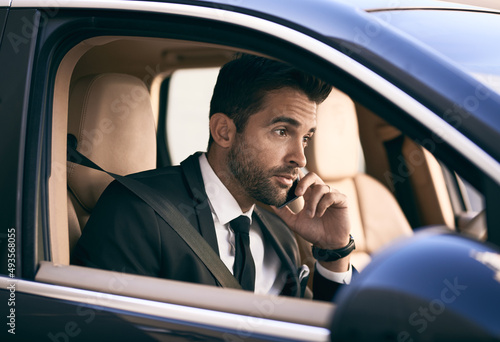 Im headed into the office right now. Cropped shot of a handsome young businessman making a phonecall while on his morning commute to work. © Nikish H/peopleimages.com