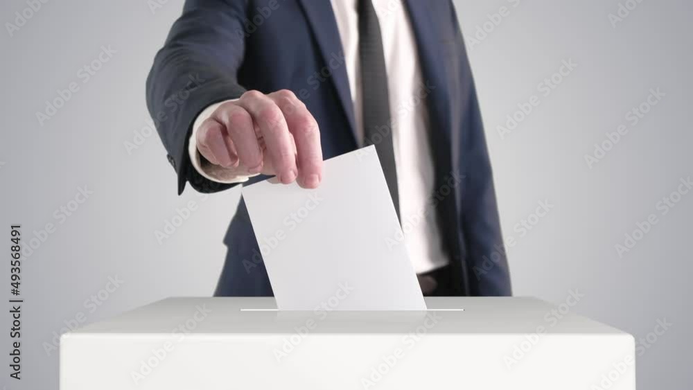 Voting. Man Putting a Ballot into a Voting Box.
Voting. Man Putting a Ballot into a Voting Box.