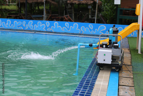 The water pump is pumping water into the pool.