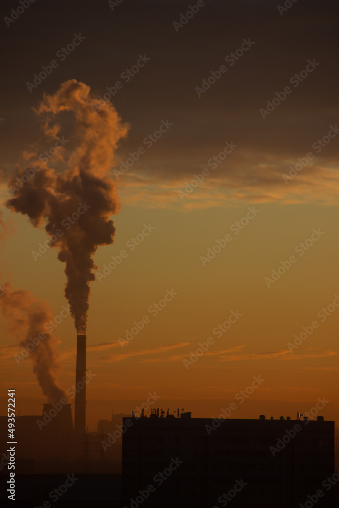 Industry metallurgical plant dawn smoke, smoke smog emissions into the environment, poor ecology. Smoke from chimneys in the rays of dawn in the city.