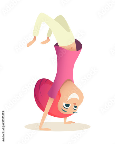 Girl has fun and stands on her hands. Child with red hair doing capoeira and smiling, side view