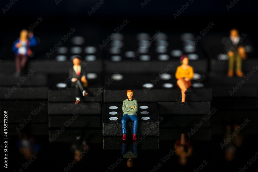 Obraz premium miniature people on dominoes Black background Macro