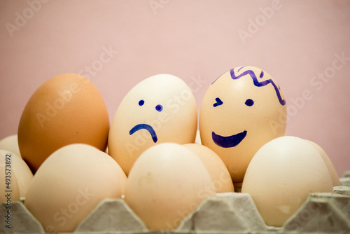 A number of eggs are filled with a pen with a facial expression.
