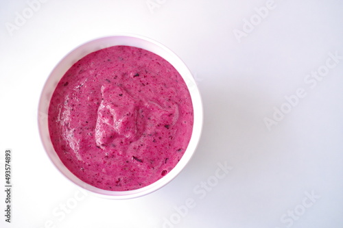 Flat lay of smoothie in a bowl against white background