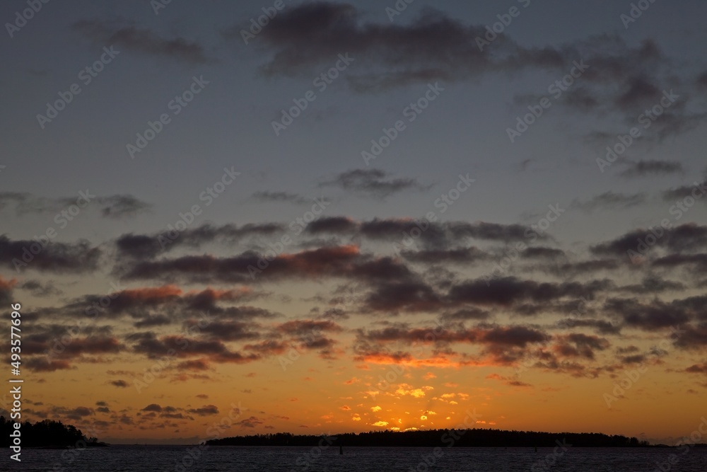Sunset with cloudy sky and silhouette of a island. Sunset with cloudy sky and silhouette of a island.