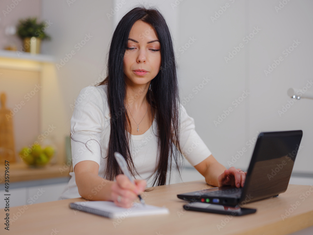 smiling young woman looking at laptop screen, reading good news in message, watching video, chatting in social network or shopping online at home, enjoying leisure time with computer smiling young woman looking at laptop screen, reading good news in message, watching video, chatting in social network or shopping online at home, enjoying leisure time with computer