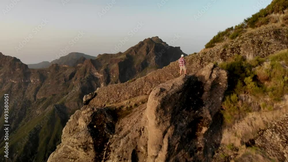 Flying over man in the tropical mountains of Madeira island, Portugal. Сoncept of freedom and spirit Flying over man in the tropical mountains of Madeira island, Portugal. Сoncept of freedom and spirit