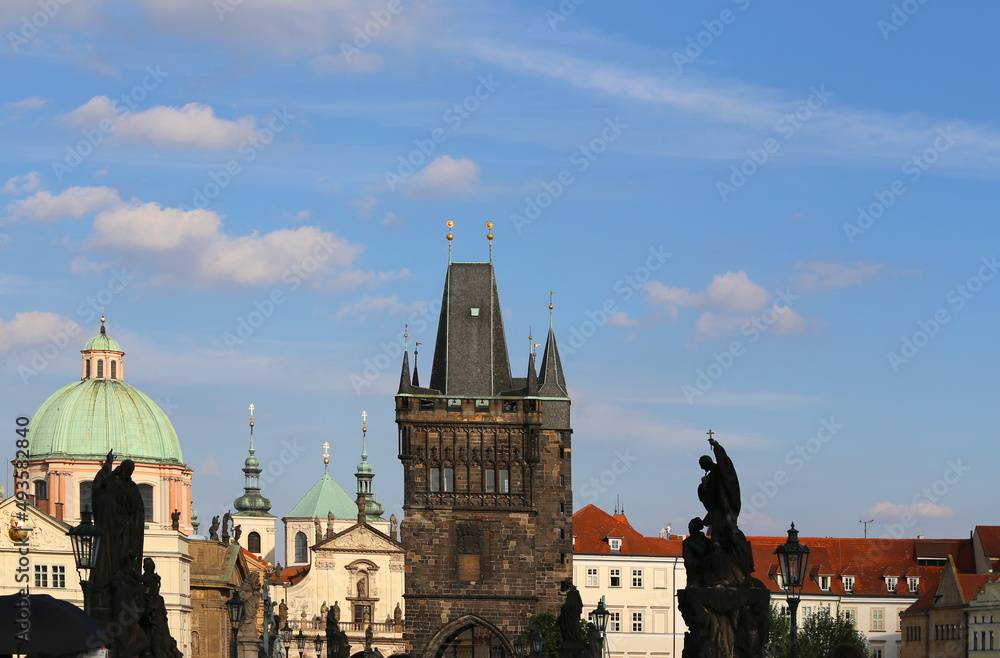 Fototapeta premium Tower of the Charles Bridge and ancient buildings in the city of Prague