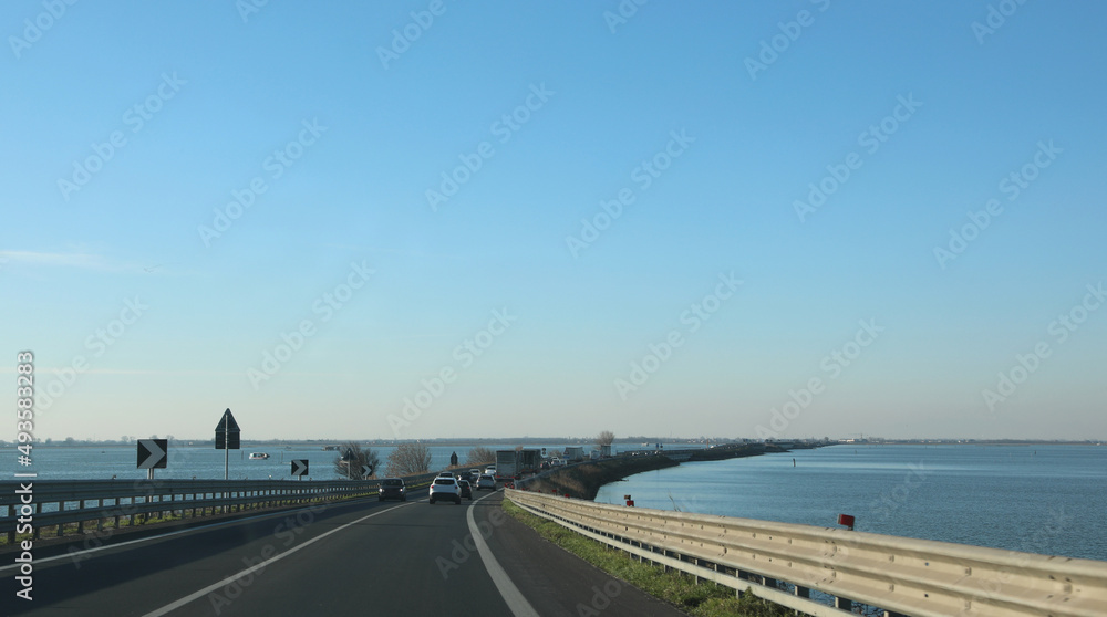long road that leads to the city of Sottomarina and Chioggia and the sea on either side