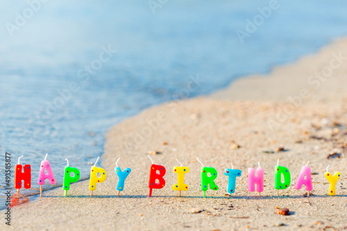Photography Happy birthday colorful candles on a beach