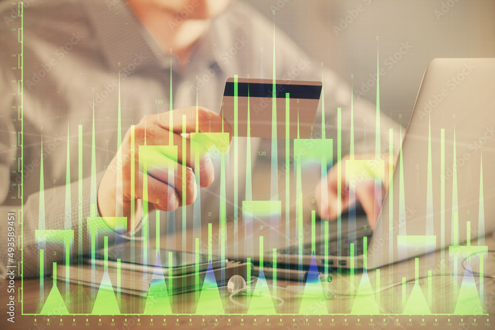 Double exposure of man hands holding a credit card and Forex graph drawing. Stock trading and digital fintech in Internet E-commerce concept. Double exposure of man hands holding a credit card and Forex graph drawing. Stock trading and digital fintech in Internet E-commerce concept.
