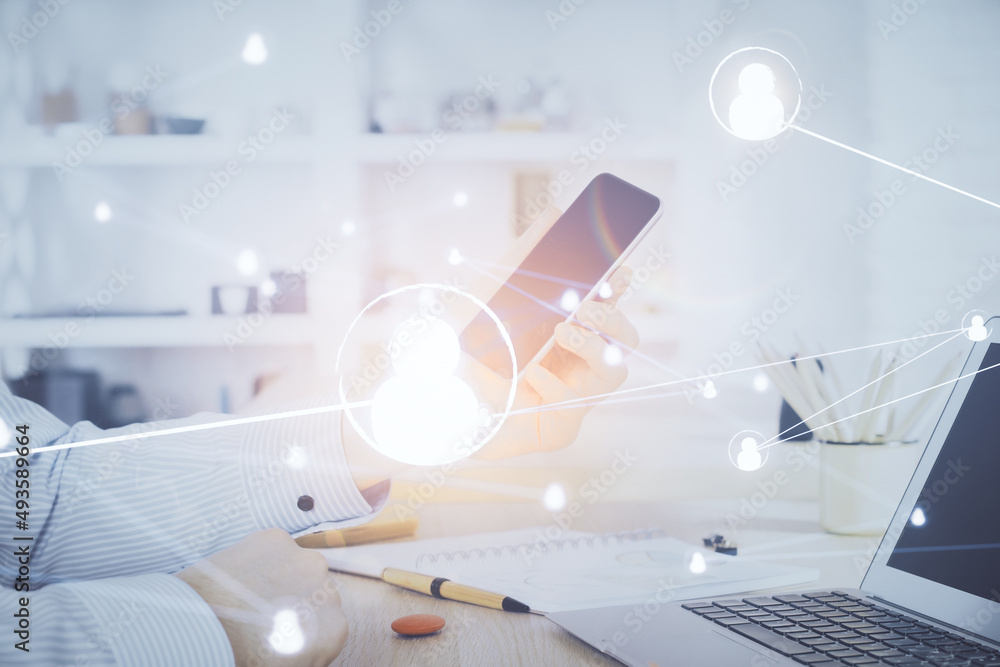 Fototapeta premium Double exposure of man's hands holding and using a phone and social network theme drawing.