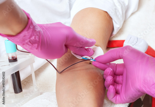 The doctor takes blood from a vein.  Prp procedure and cosmetology concept.