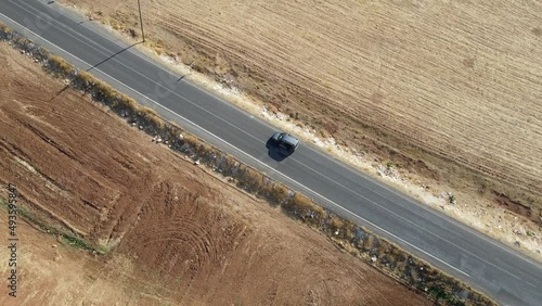  Gray car drives along a deserted road. View from above. 