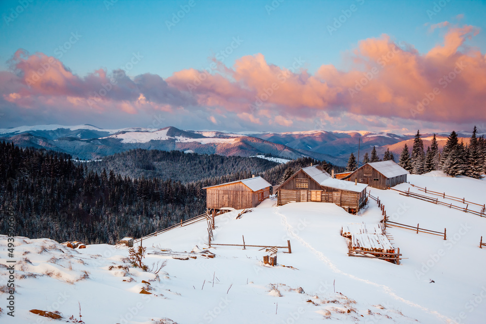 Snow-capped mountain huts in the frosty day.