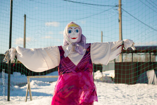 A effigy stuffed woman in winter. A female scarecrow is also pagan. photo