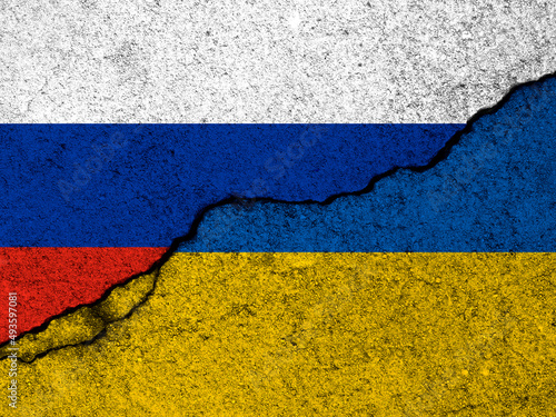 Russia and Ukraine flags. War crisis, political conflict. Cracked concrete wall background