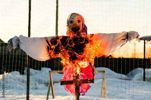 Scarecrow of a woman is on fire. The effigy at the Shrovetide festival is burning. photo