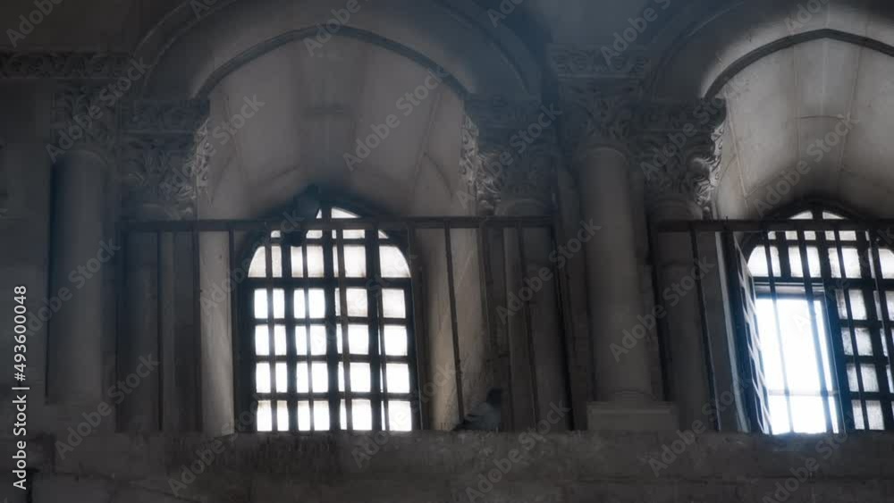 Light rays coming into the church through high windows. Slow motion. Light rays coming into the church through high windows. Slow motion.