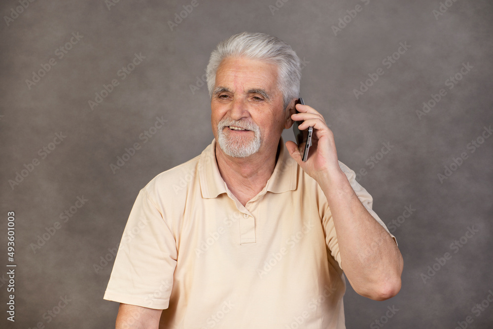Retired , Senior man with gray hair with mobile phone Retired , Senior man with gray hair with mobile phone
