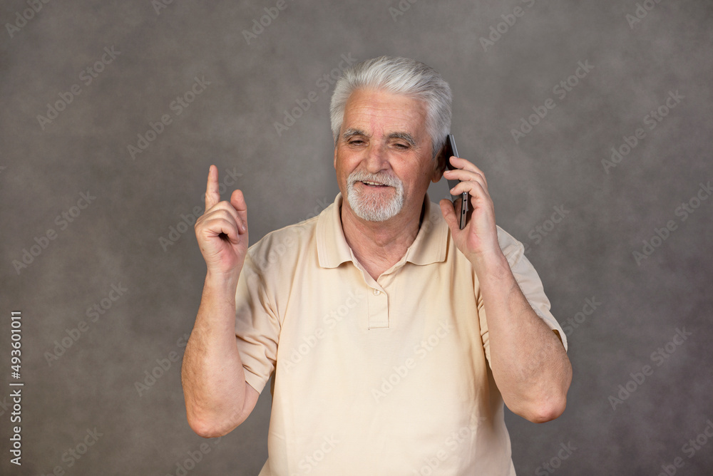 Retired , Senior man with gray hair with mobile phone Retired , Senior man with gray hair with mobile phone