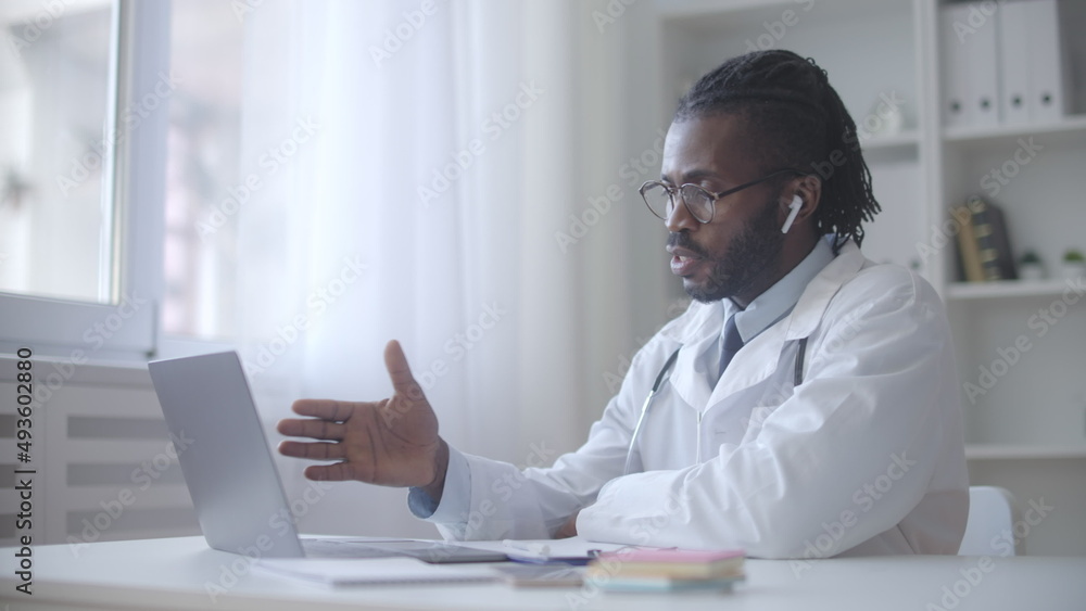 Enthusiastic black doctor consulting patient via video chat, online check-up Enthusiastic black doctor consulting patient via video chat, online check-up