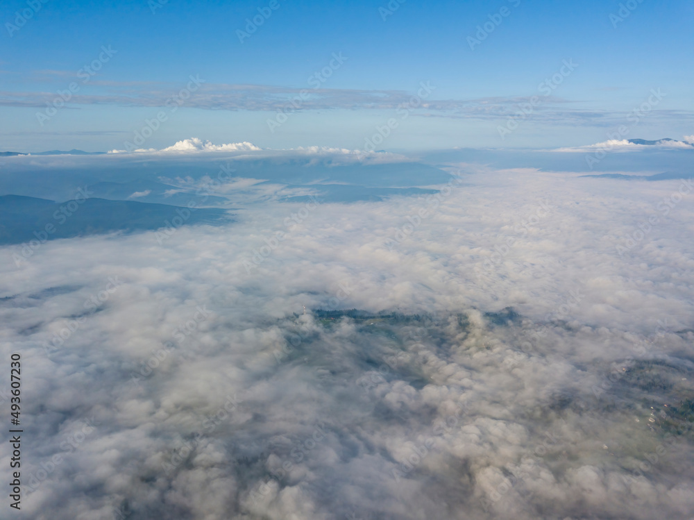 High flight above the clouds in the mountains. Aerial drone view. High flight above the clouds in the mountains. Aerial drone view.